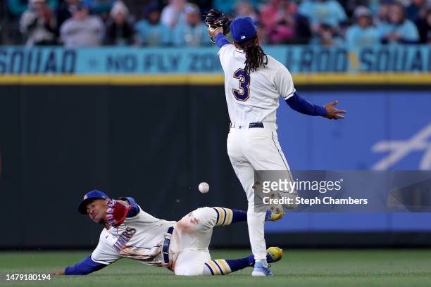 Julio Rodriguez and J.P. Crawford of the Seattle Mariners nearly collide on a double by Mike Zunino of the Cleveland Guardians during the seventh...