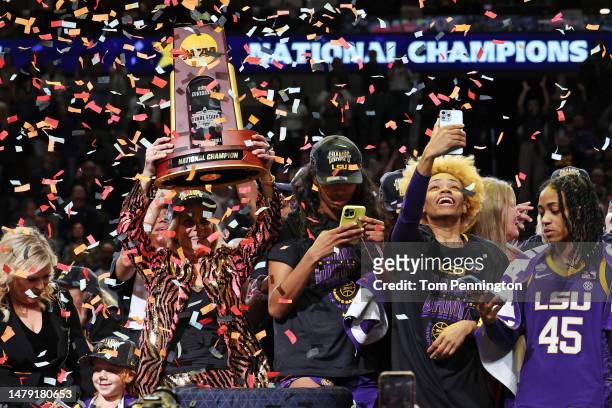 Head coach Kim Mulkey of the LSU Lady Tigers holds the championship trophy after defeating the Iowa Hawkeyes 102-85 during the 2023 NCAA Women's...