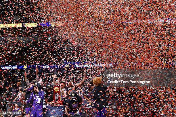 Angel Reese of the LSU Lady Tigers holds the championship trophy as the Tigers celebrate defeating the Iowa Hawkeyes 102-85 during the 2023 NCAA...