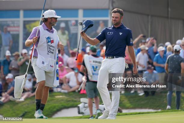 Corey Conners of Canada and caddie Danny Sahl celebrate on the 18th green after winning the Valero Texas Open at TPC San Antonio on April 02, 2023 in...