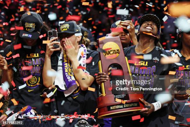 The LSU Lady Tigers players hold the championship trophy after defeating the Iowa Hawkeyes 102-85 during the 2023 NCAA Women's Basketball Tournament...