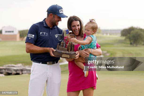 Corey Conners of Canada poses with the trophy with wife Malory and daughter Reis after winning the Valero Texas Open at TPC San Antonio on April 02,...