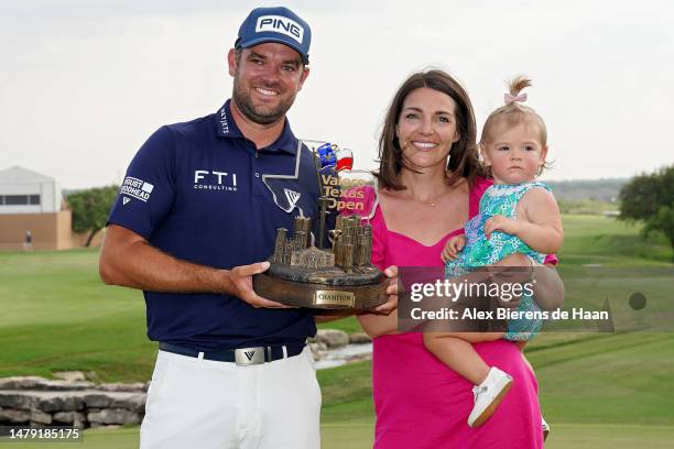 Corey Conners of Canada poses with the trophy with wife Malory and daughter Reis after winning the Valero Texas Open at TPC San Antonio on April 02,...