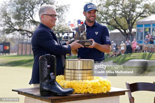 Corey Conners of Canada is presented with the trophy after winning the Valero Texas Open at TPC San Antonio on April 02, 2023 in San Antonio, Texas.