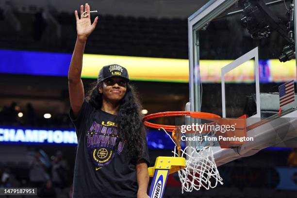 Angel Reese of the LSU Lady Tigers cuts down a piece of the net after defeating the Iowa Hawkeyes 102-85 during the 2023 NCAA Women's Basketball...