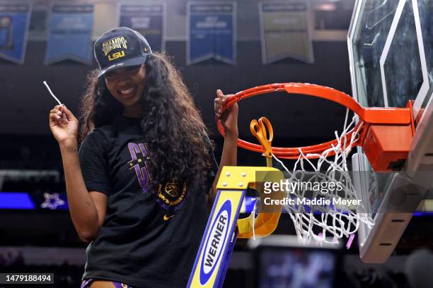 Angel Reese of the LSU Lady Tigers cuts down a piece of the net after defeating the Iowa Hawkeyes 102-85 during the 2023 NCAA Women's Basketball...