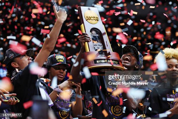 Lady Tigers players hold up the championship trophy after defeating the Iowa Hawkeyes 102-85 during the 2023 NCAA Women's Basketball Tournament...