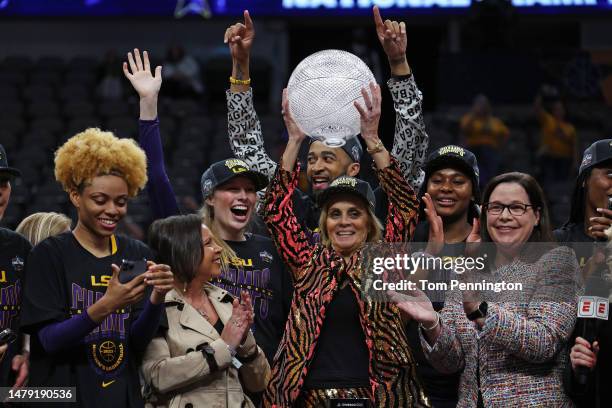 Head coach Kim Mulkey of the LSU Lady Tigers holds the Invesco QQQ WBCA Coaches’ Trophy after defeating the Iowa Hawkeyes 102-85 during the 2023 NCAA...