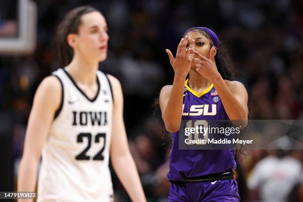 Angel Reese of the LSU Lady Tigers reacts towards Caitlin Clark of the Iowa Hawkeyes during the fourth quarter during the 2023 NCAA Women's...