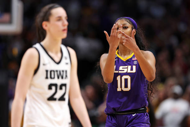 Angel Reese of the LSU Lady Tigers reacts towards Caitlin Clark of the Iowa Hawkeyes during the fourth quarter during the 2023 NCAA Women's...