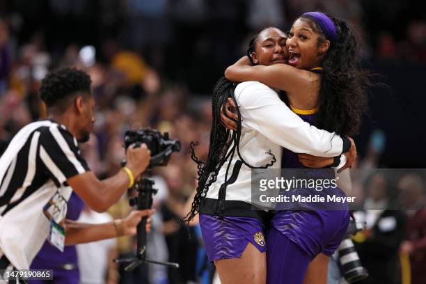 Angel Reese of the LSU Lady Tigers celebrates with a teammate after defeating the Iowa Hawkeyes 102-85 during the 2023 NCAA Women's Basketball...