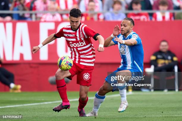 Arnau Martinez of Girona FC is challenged by Martin Braithwaite of RCD Espanyol during the LaLiga Santander match between Girona FC and RCD Espanyol...