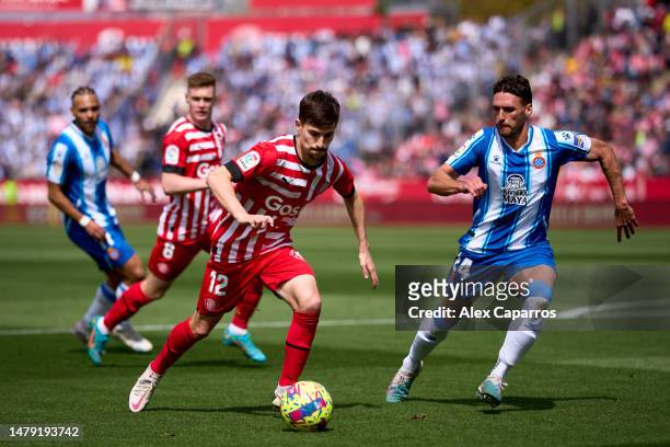 Toni Villa of Girona FC runs with the ball whilst under pressure from Sergi Gomez of RCD Espanyol during the LaLiga Santander match between Girona FC...