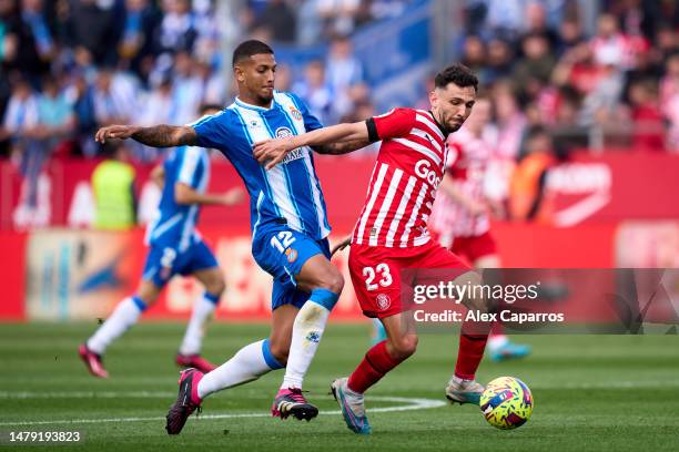 Ivan Martin of Girona FC is challenged by Vinicius 'Vini' De Souza of RCD Espanyol during the LaLiga Santander match between Girona FC and RCD...