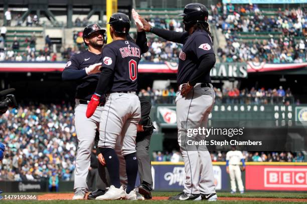 Mike Zunino of the Cleveland Guardians celebrates his three run home run with Andres Gimenez and Josh Bell against the Seattle Mariners during the...