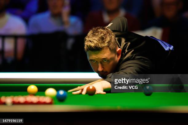 Kyren Wilson of England plays a shot in the final match against Shaun Murphy of England on day seven of Tour Championship Snooker 2023 at the Bonus...