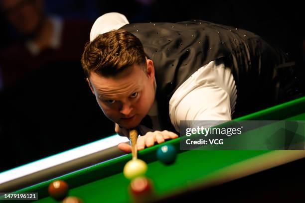 Shaun Murphy of England plays a shot in the final match against Kyren Wilson of England on day seven of Tour Championship Snooker 2023 at the Bonus...