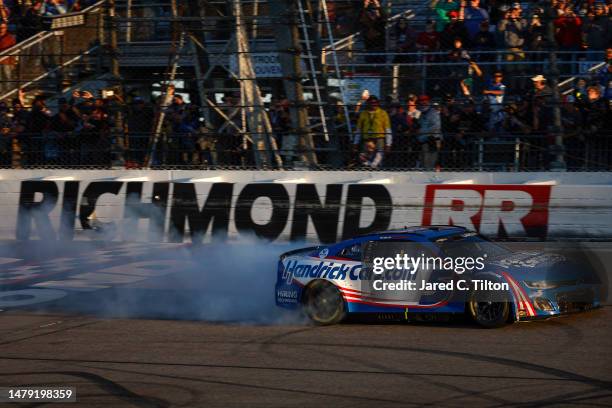 Kyle Larson, driver of the HendrickCars.com Chevrolet, celebrates with a burnout after winning the NASCAR Cup Series Toyota Owners 400 at Richmond...