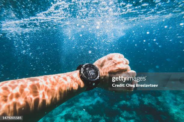 waterproof smartwatches on man's hand underwater. freediving activity - free diving stock pictures, royalty-free photos & images