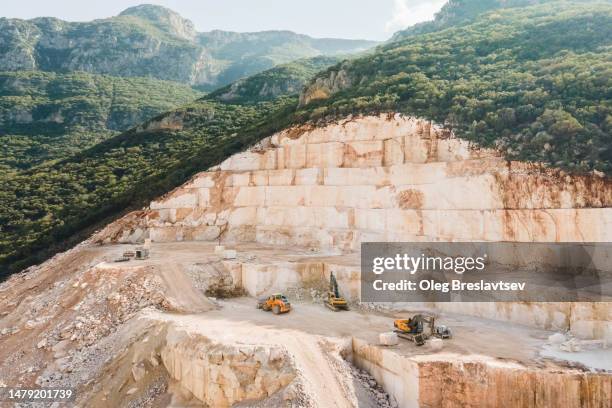 open pit stone mining in mountains. no environmental protection, ecology problem - open pit mine stock pictures, royalty-free photos & images