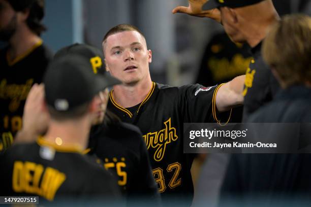 Henry Davis of the Pittsburgh Pirates is greeted in the dugout after scoring a run in the fifth inning against the Los Angeles Dodgers at Dodger...