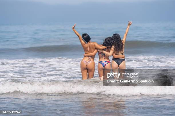 friends gesturing happiness inside the water of the sea - the sea inside stock pictures, royalty-free photos & images