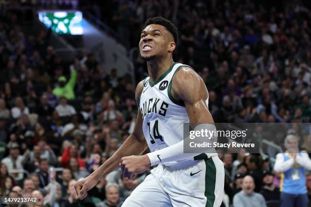 Giannis Antetokounmpo of the Milwaukee Bucks reacts to a dunk against the Philadelphia 76ers during the first half of a game at Fiserv Forum on April...