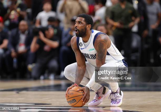 Kyrie Irving of the Dallas Mavericks reacts after he was charged with a foul against Trae Young of the Atlanta Hawks in the final seconds of overtime...