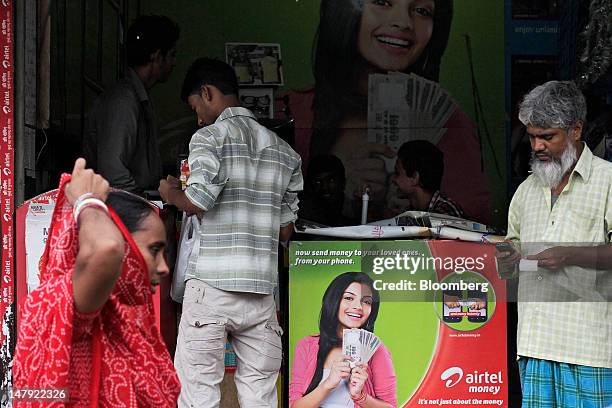 An advertisement for Bharti Airtel Ltd. Mobile banking is displayed at a mobile phone store in Mumbai, India, on Wednesday, July 4, 2012. In India,...