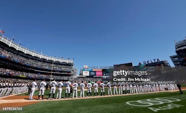 The New York Yankees stand during the national anthem before their Opening Day game against the San Francisco Giants at Yankee Stadium on March 30,...