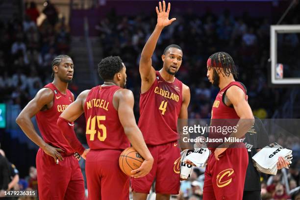Caris LeVert Donovan Mitchell Evan Mobley and Lamar Stevens of the Cleveland Cavaliers talk during a timeout during the third quarter against the...