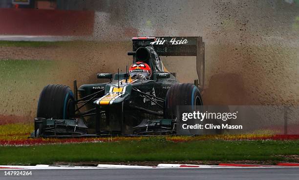 Heikki Kovalainen of Finland and Caterham slids off the track in the wet during practice for the British Grand Prix at Silverstone Circuit on July 6,...
