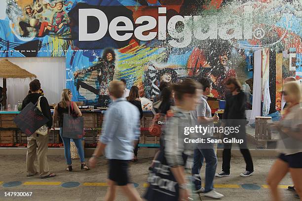 Visitors walk past the desigual stand at the 2012 Bread & Butter fashion trade fair at former Tempelhof Airport on July 6, 2012 in Berlin, Germany....