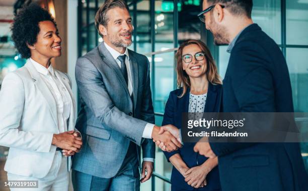 greeting for the success - partnership handshake stock pictures, royalty-free photos & images