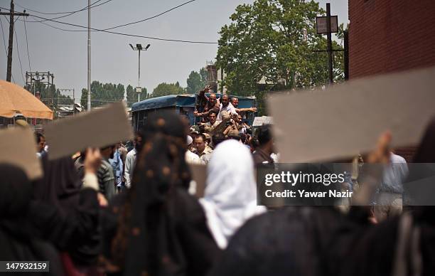 Detained separatist leaders shout anti-Indian slogans from the inside of an police vehicle during a protest on July 6, 2012 in Srinagar, the summer...