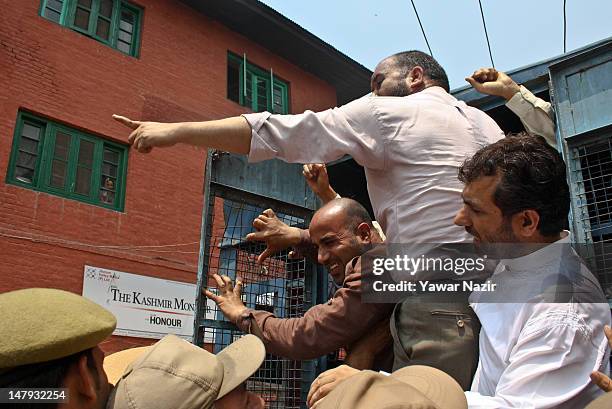 Detained separatist leaders shout anti-Indian slogans from the inside of an police vehicle during a protest on July 6, 2012 in Srinagar, the summer...