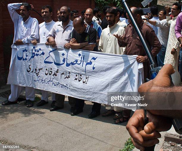 Separatist leaders hold a banner which reads "we are waiting for justice" as they shout anti-Indian slogans during a protest on July 6, 2012 in...