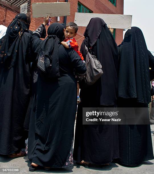 Members of the Muslim Khawateen Markaz , a women's separatist organization, along with with family members of Ghulam Mohammed Khan Sopori hold...