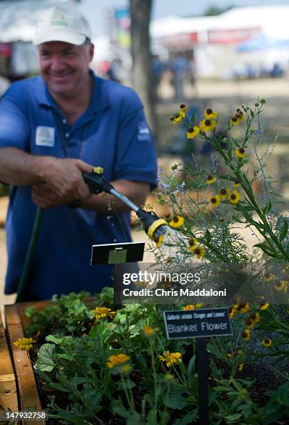 Volunteer Steve Lombardi waters an "accessible garden" at the annual Smithsonian Folklife Festival on the Mall. One of this year's themes is "Campus...