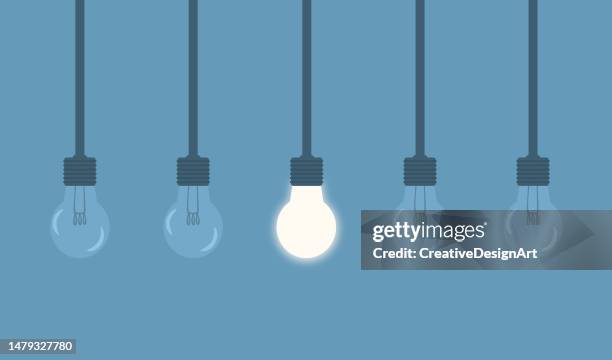 standing out from the crowd, think differently, individuality and leadership concept with hanging light bulbs with glowing one on blue background - learn to lead stock illustrations