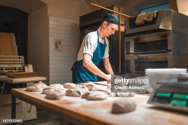 caucasian baker working in an artisan bakery - kneading stock pictures, royalty-free photos & images