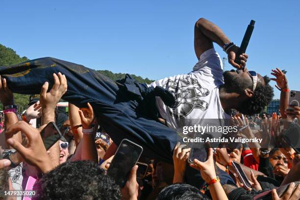 Roscoe Dash crowd surfs as he performs with Waka Flocka Flame during the 2023 Dreamville Festival at Dorothea Dix Park on April 02, 2023 in Raleigh,...