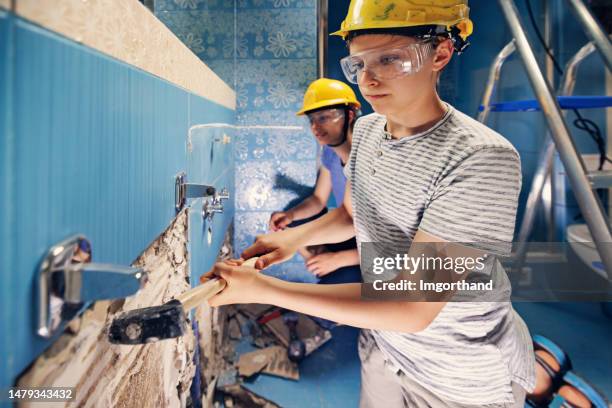 teenagers doing some home demolition - renovation - demolishing stock pictures, royalty-free photos & images