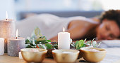 Relax, spa and zen woman with candles for beauty, physical therapy or skincare. Female client on table with candle in ambient room for cosmetics or luxury treatment for skin, health and wellness