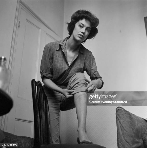 Actress Patricia Haines with a rolled up trouser leg, shows a bruise to her shin, October 7th, 1958.