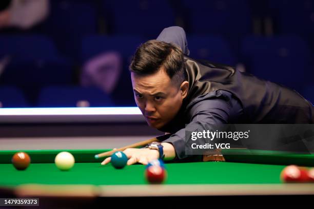 Marco Fu of Hong Kong plays a shot in the qualifying match against Martin O'Donnell of England ahead of the 2023 Cazoo World Snooker Championship at...