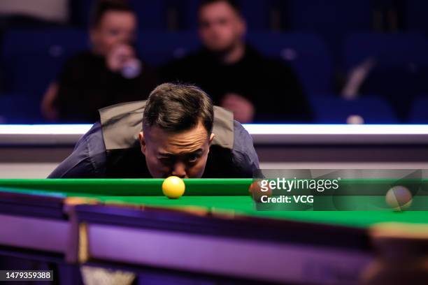 Marco Fu of Hong Kong eyes the ball in the qualifying match against Martin O'Donnell of England ahead of the 2023 Cazoo World Snooker Championship at...