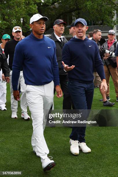 Tiger Woods of the United States and Rory McIlroy of Northern Ireland walk to the tenth tee during a practice round prior to the 2023 Masters...