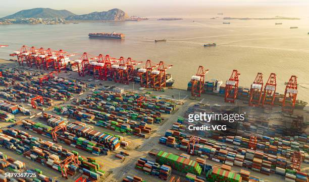 Aerial view of large container vessels and shipping containers at Yangshan Deep-Water Port on April 1, 2023 in Shanghai, China. Yangshan port, an...
