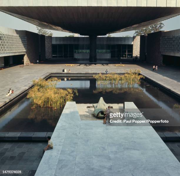 Visitors in the central courtyard of the National Museum of Anthropology located within Chapultepec Park in Mexico City, capital of Mexico circa...